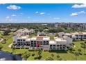Condo building showcasing private balconies and tranquil surroundings at 50 Coe Rd # 224, Belleair, FL 33756