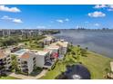 Aerial view of condo community with water access and lush landscaping at 50 Coe Rd # 224, Belleair, FL 33756