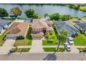 Bird's eye view of a house near a lake, showcasing neighborhood and backyard at 11302 Southwind Lake Dr, Gibsonton, FL 33534