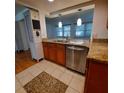Kitchen with wood cabinets, granite countertops, and tiled floor at 10011 40Th N St # 3, Pinellas Park, FL 33782