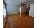 Spacious living room with laminate wood flooring and a ceiling fan at 10011 40Th N St # 3, Pinellas Park, FL 33782
