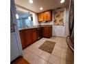 Kitchen with wood cabinets, granite countertops, and tiled floor at 10011 40Th N St # 3, Pinellas Park, FL 33782