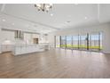 Bright, open-concept living space with modern flooring, recessed lighting, and sliding doors to the backyard at 12977 Long Valley Cir, Spring Hill, FL 34609