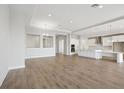 Spacious open-concept living area with modern flooring flowing into the kitchen at 12977 Long Valley Cir, Spring Hill, FL 34609