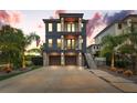 Modern two-story home featuring a two-car garage, dual balconies, and manicured landscaping at 2600 Quincy S St, Gulfport, FL 33711