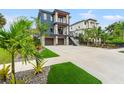 Beautifully landscaped front yard with a modern home, two-car garage, and lush green lawn at 2600 Quincy S St, Gulfport, FL 33711