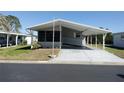Charming single-story home featuring a covered carport and well-kept landscaping at 34045 Brown Bayou, Wesley Chapel, FL 33543