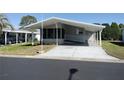 Inviting single-story home with a covered carport and a tidy front yard at 34045 Brown Bayou, Wesley Chapel, FL 33543