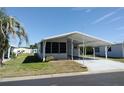 Attractive single-story home with a covered carport and a lush lawn at 34045 Brown Bayou, Wesley Chapel, FL 33543