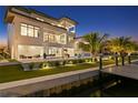 Luxury waterfront home with pool and private dock at sunset at 490 Laguna Dr, Tierra Verde, FL 33715