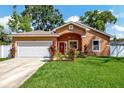 Newly built tan house with a white garage door and red front door at 2769 48Th N Ave, St Petersburg, FL 33714