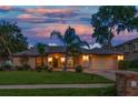Charming home featuring a manicured lawn, lush landscaping, a symmetrical design, and a two-car garage at 1105 Deer Run Pl, Valrico, FL 33594