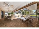 Spacious screened patio with a dining table, comfortable seating, and relaxing lounge chairs at 1105 Deer Run Pl, Valrico, FL 33594