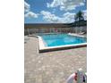 Community pool with surrounding patio and lounge chairs at 8100 Dr Martin Luther King Jr N St # 208, St Petersburg, FL 33702