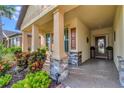 Covered porch with stone columns and potted plants at 6342 Kenava Loop, Palmetto, FL 34221