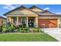 One-story house with orange garage door and landscaped yard at 6342 Kenava Loop, Palmetto, FL 34221
