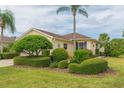 Yellow house with nicely landscaped yard at 1908 Sterling Glen Ct, Sun City Center, FL 33573