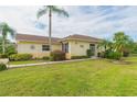 Yellow house exterior with a nicely landscaped yard at 1908 Sterling Glen Ct, Sun City Center, FL 33573