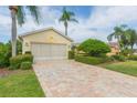 Two car garage with a paved driveway at 1908 Sterling Glen Ct, Sun City Center, FL 33573