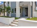 Modern home entrance with gray siding and a white wall at 2138 - 2 W Beach St, Tampa, FL 33607