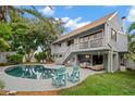 Inviting backyard with a sparkling pool, outdoor seating, and a covered patio with comfortable lounge furniture at 1118 2Nd S Ave, Tierra Verde, FL 33715