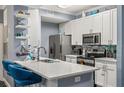 Modern kitchen with white cabinets, quartz countertops, and stainless steel appliances at 17104 Carrington Park Dr # 520, Tampa, FL 33647