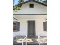 Gray front door and white porch with decorative railing at 3407 E 10Th Ave, Tampa, FL 33605