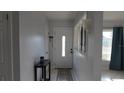 Bright foyer with a white front door, tiled floor, and a view into the adjacent living spaces at 5805 Oxford Dr, Tampa, FL 33615