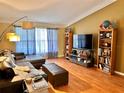 Living room with L-shaped sectional sofa and built-in shelving at 2321 Rothenfeld Ct, Land O Lakes, FL 34639