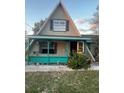 A-frame home with teal accents and small front yard at 4530 Flounder Dr, Hernando Beach, FL 34607