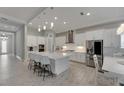 Modern kitchen with large island and stainless steel appliances at 5608 Madrigal Way, Apollo Beach, FL 33572