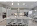 Modern kitchen with large island and stainless steel appliances at 5608 Madrigal Way, Apollo Beach, FL 33572