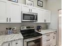 Stainless steel appliances and granite countertops in this updated kitchen at 406 S Bayview Blvd # 1, Oldsmar, FL 34677