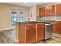 Kitchen with island, stainless steel appliances, and wood cabinets at 10708 Bamboo Rod Cir, Riverview, FL 33569