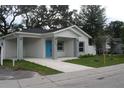 Newly built home with a bright blue front door and landscaping at 4004 E Osborne Ave, Tampa, FL 33610