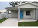 Newly built home with covered porch and concrete driveway at 4004 E Osborne Ave, Tampa, FL 33610