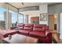 Living room with red sectional sofa and city views at 777 N Ashley Dr # 1606, Tampa, FL 33602