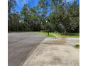 Empty lot with paved driveway and walkway at 34735 Double Eagle Ct, Zephyrhills, FL 33541