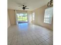 Spacious living room featuring tile floors and access to a screened patio at 34735 Double Eagle Ct, Zephyrhills, FL 33541