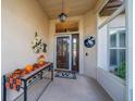 Front entryway with tiled flooring, a decorative console table and wreath at 739 Winterbrooke Way, Sun City Center, FL 33573