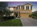 Two-story house with a two-car garage and landscaping at 35744 Jenny Lynne Cir, Zephyrhills, FL 33541