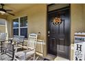 Inviting front porch with rocking chairs and fall decor at 35744 Jenny Lynne Cir, Zephyrhills, FL 33541