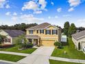 Aerial view of two-story house with landscaping and a neighborhood view at 35744 Jenny Lynne Cir, Zephyrhills, FL 33541