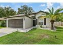 One-story home with brown garage door and landscaped lawn at 9733 Long Meadow Dr, Tampa, FL 33615