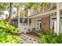 Charming patio with decorative furniture and lush garden, perfect for outdoor relaxation at 9 Pelican Pl, Belleair, FL 33756