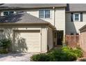 Townhouse exterior with neutral siding, brick details, and lush landscaping at 9 Pelican Pl, Belleair, FL 33756