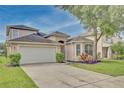 Two-story house with attached garage and manicured lawn at 7110 Moss Ledge Run, Land O Lakes, FL 34637