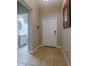 Bright entryway with tile floors and access to a half bathroom at 10215 Count Fleet Dr, Ruskin, FL 33573