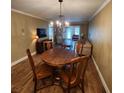 Charming dining area with wood table and chandelier at 3679 Trophy Blvd, New Port Richey, FL 34655