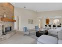 Spacious living room with a brick fireplace, neutral decor, and seamless connection to the kitchen and entryways at 4251 Preserve Pl, Palm Harbor, FL 34685
